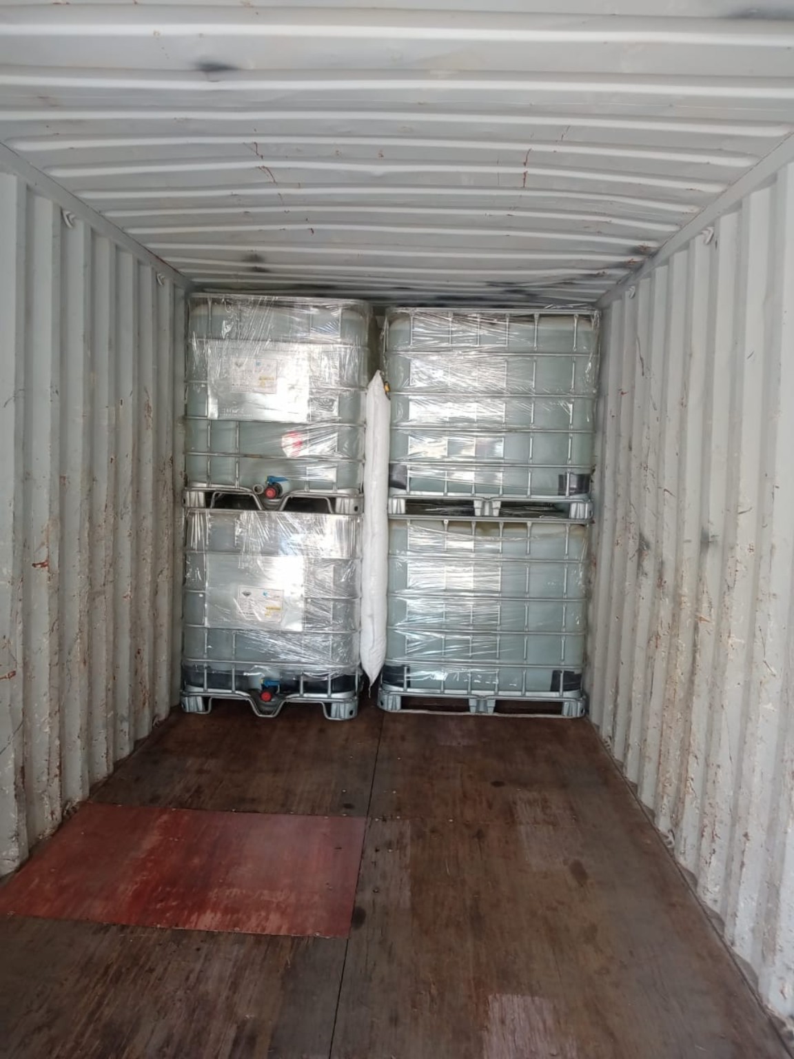 Wrapped bulk containers secured inside a shipping container